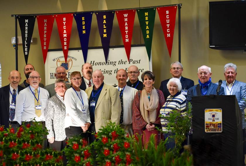 A group of people standing in front of a podium

Description automatically generated